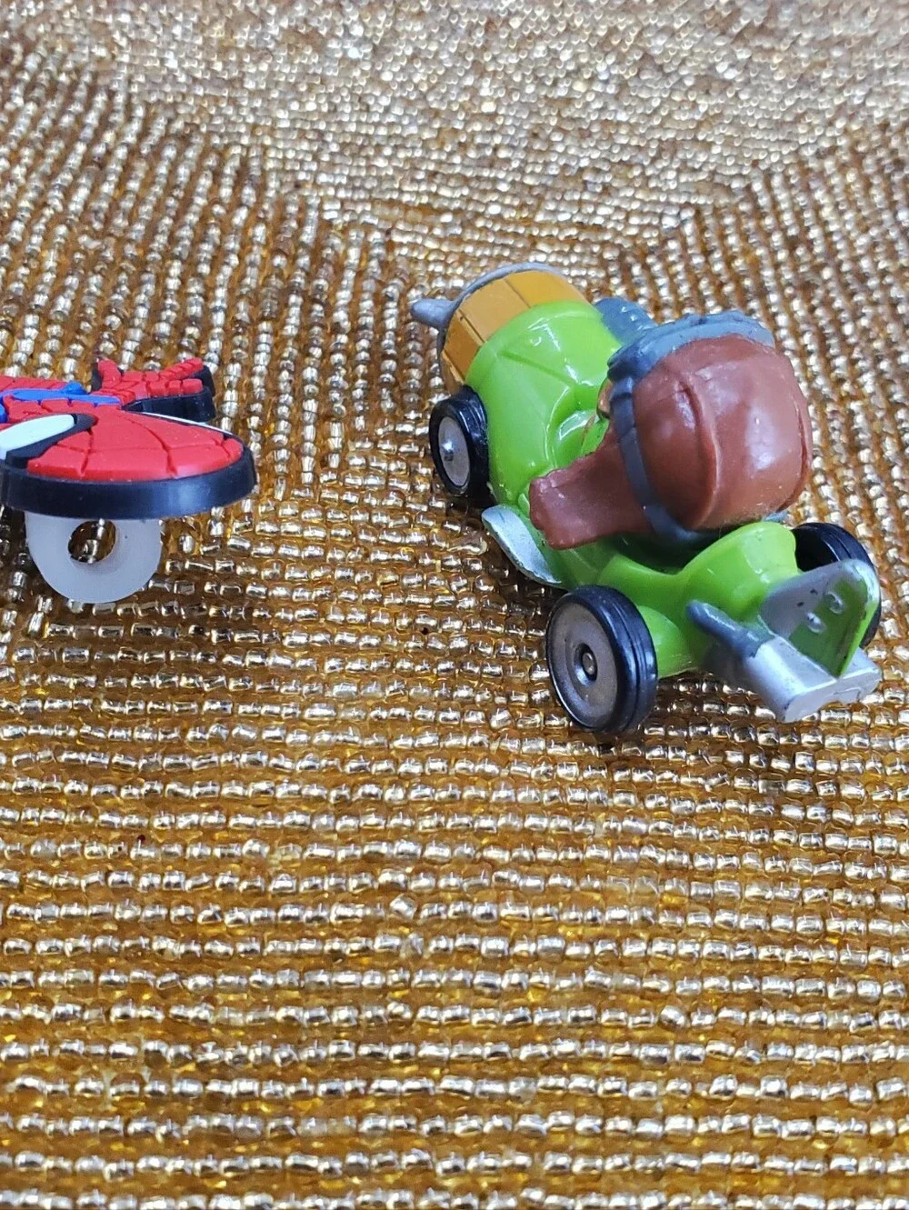Mix of 9  small toy figures, miniature vehicles, and character charms. (C40)